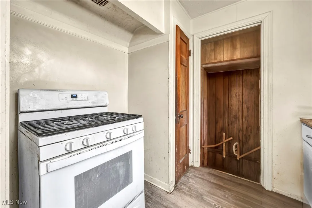Kitchen with gas range gas stove and wood finished floors