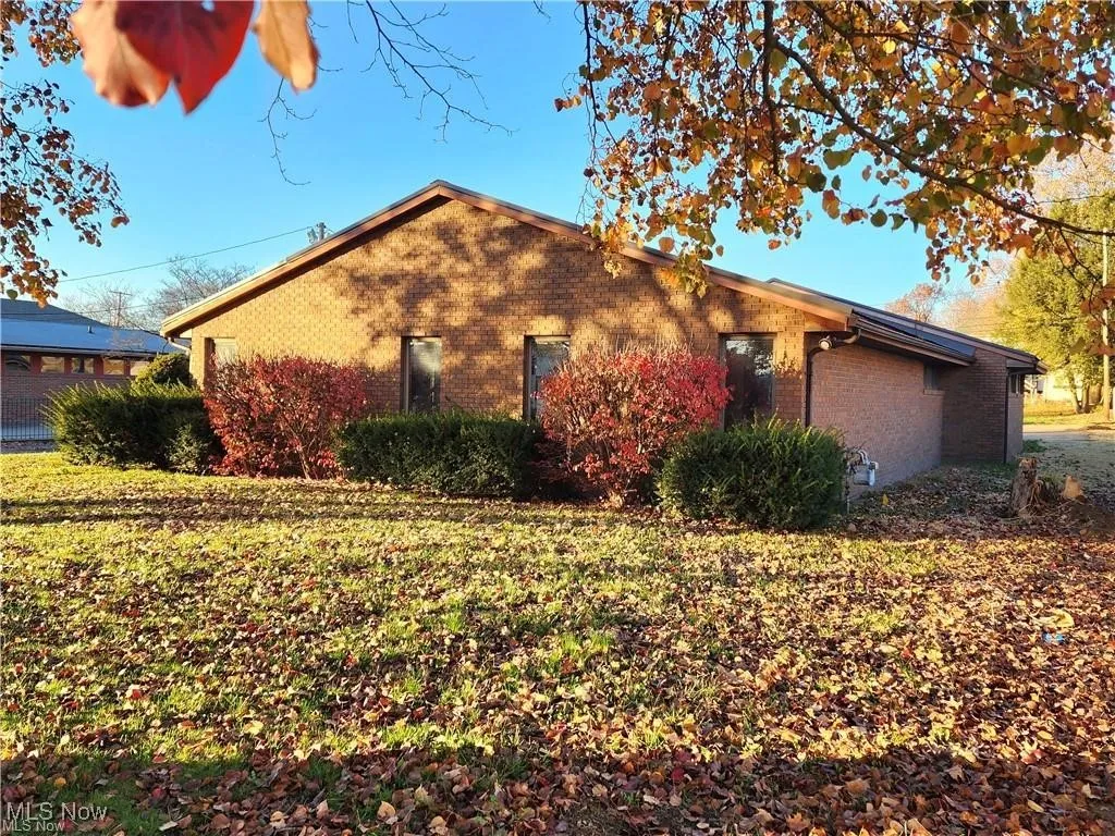 View of side of home featuring a lawn