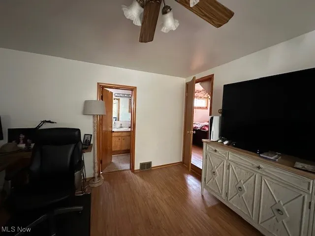 Office featuring wood finished floors, a ceiling fan, and baseboards