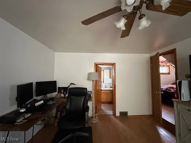 Office space featuring wood finished floors and ceiling fan