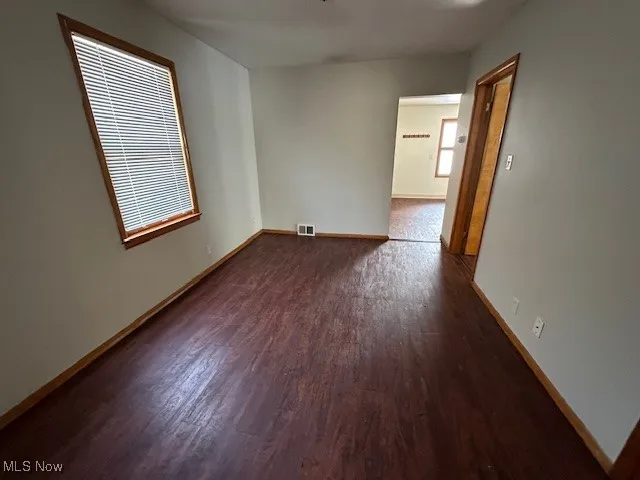 Spare room featuring dark hardwood / wood-style flooring