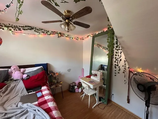 Bedroom 3 with wood finished floors, a ceiling fan, and baseboards