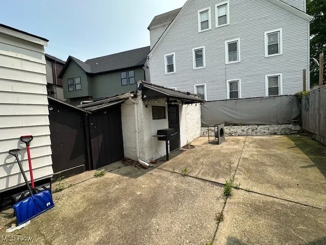 Rear view of house featuring a fenced backyard and a patio