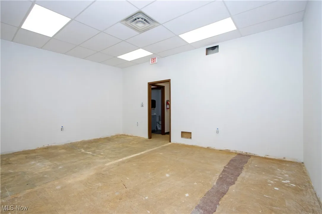 Unfurnished room featuring a drop ceiling