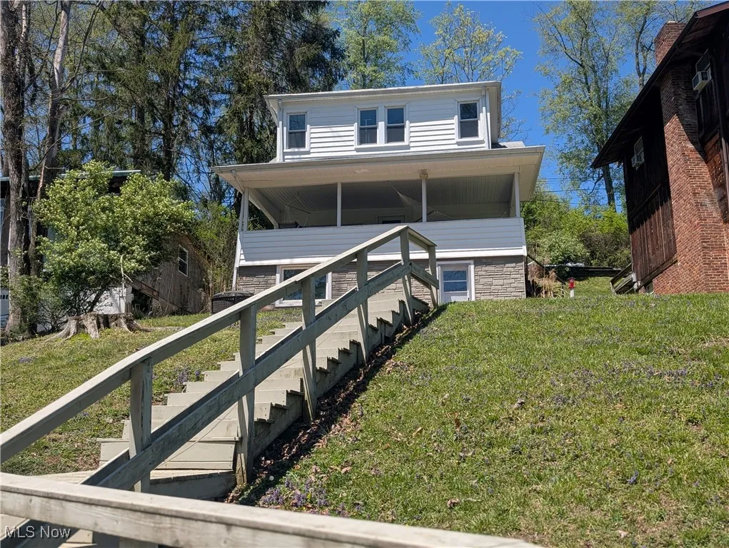 View of front of house featuring a front yard and stairs