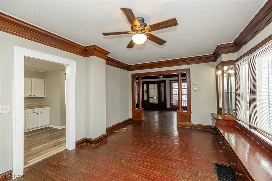 Hall with dark hardwood / wood-style floors and ornamental molding
