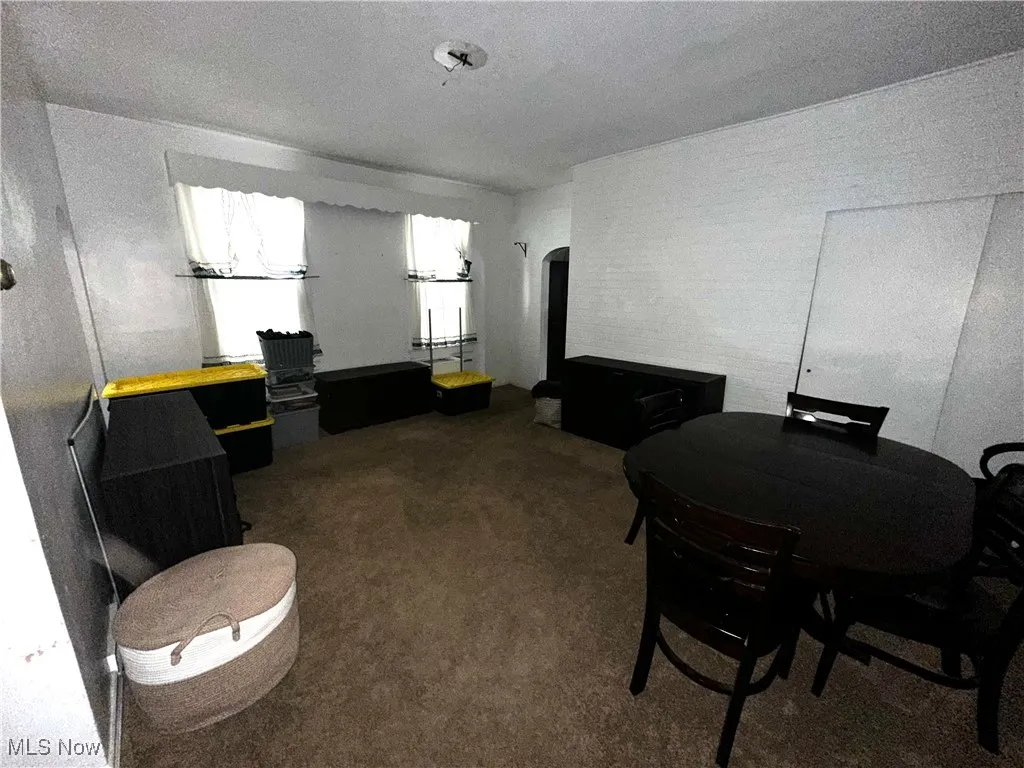 Home office featuring dark colored carpet