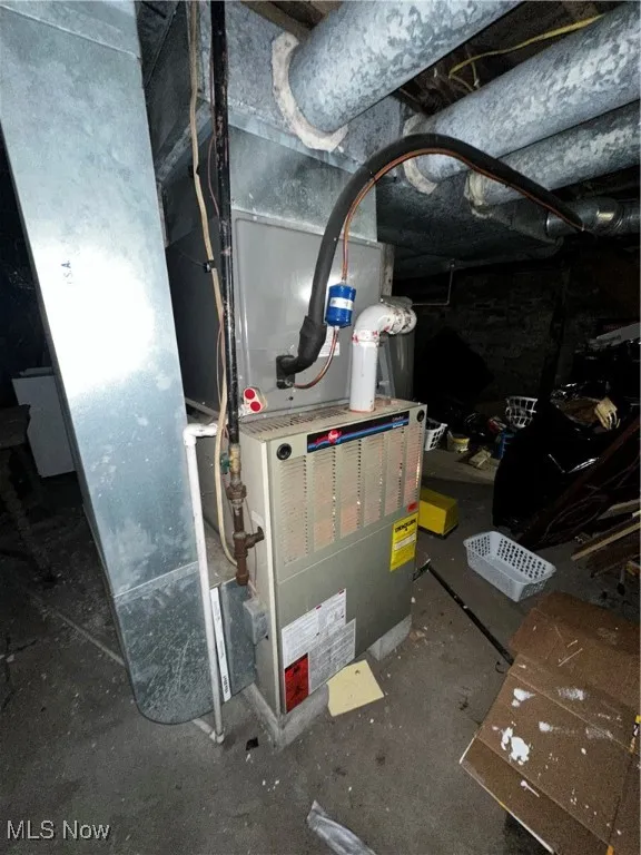 Utility room featuring heating unit