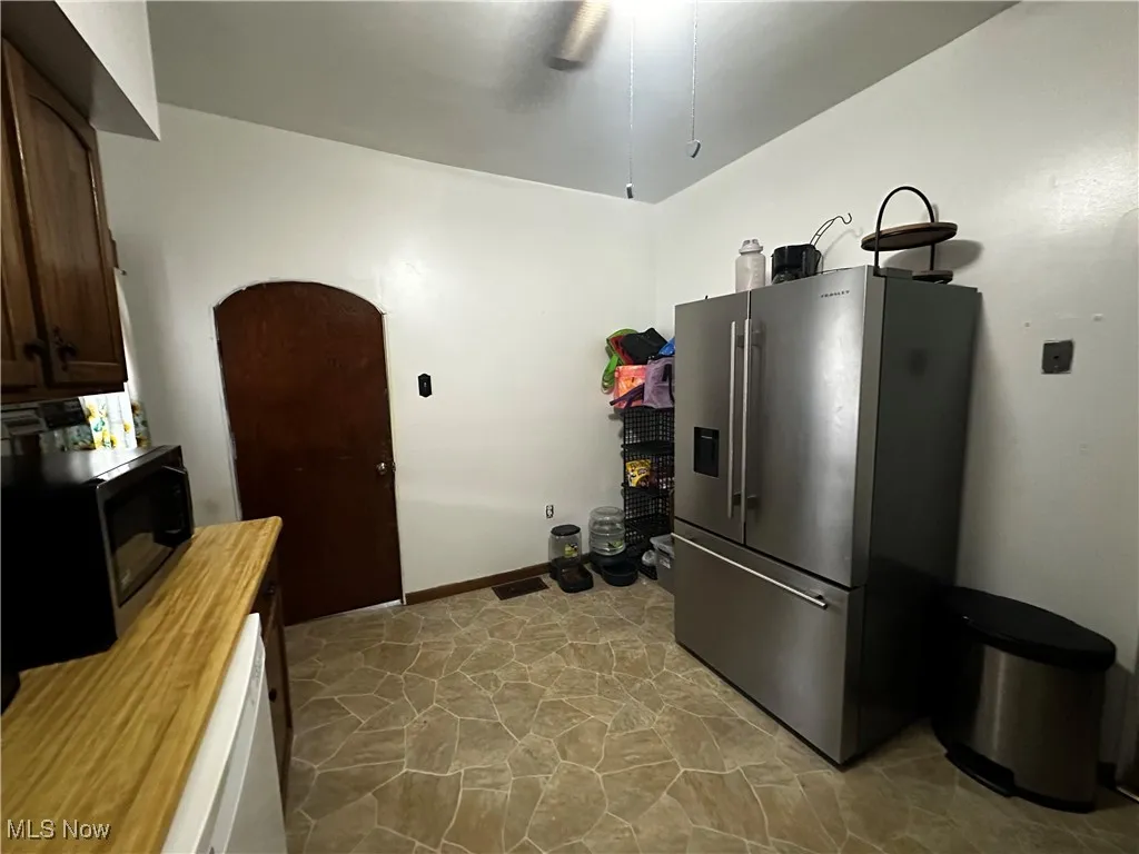 Kitchen with ceiling fan and high end fridge