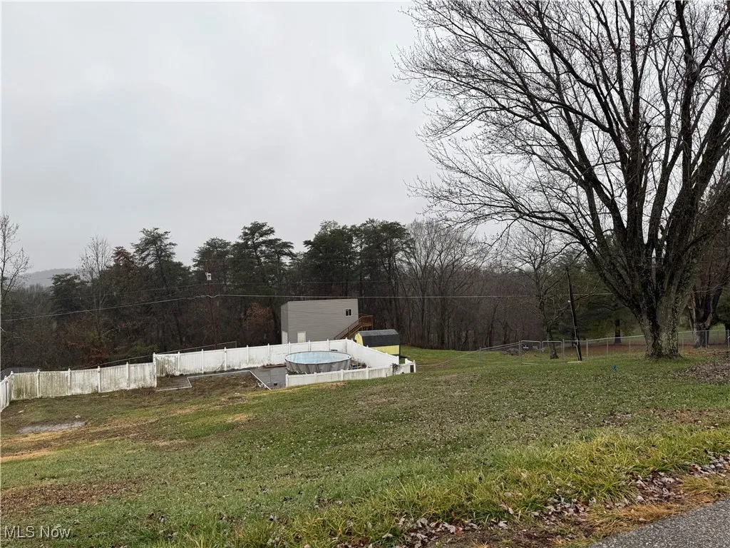 View of yard featuring fence