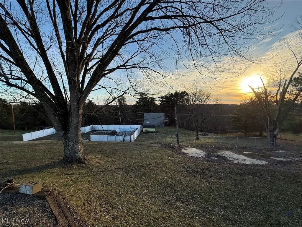 Yard at dusk with fence