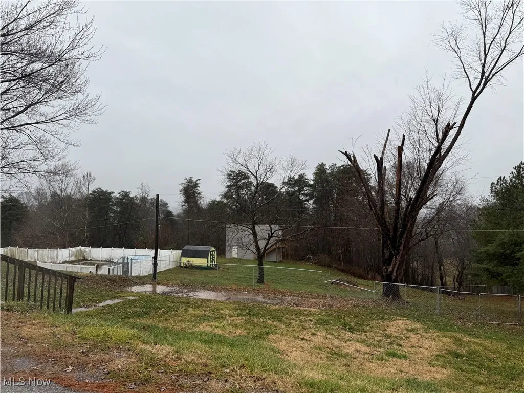 View of yard featuring fence