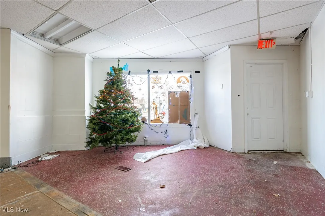 Unfurnished room with a drop ceiling