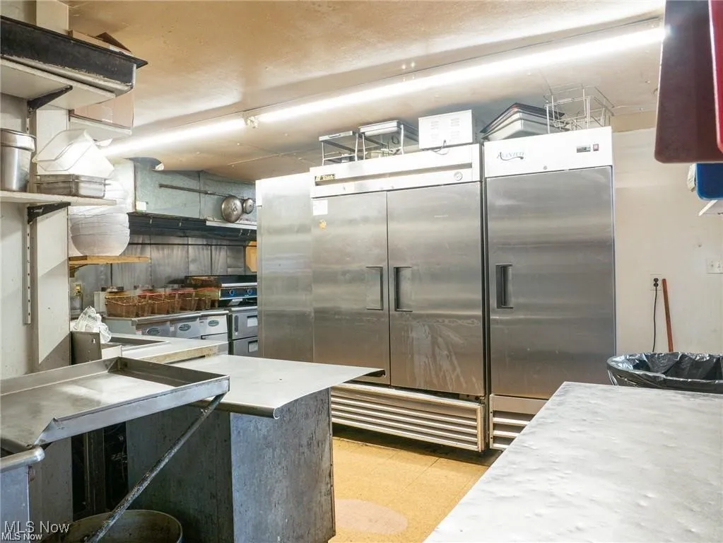 Kitchen featuring stainless steel built in refrigerator