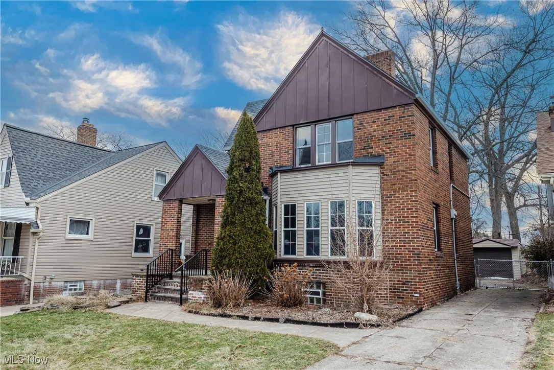 View of front of home featuring a garage and a front yard