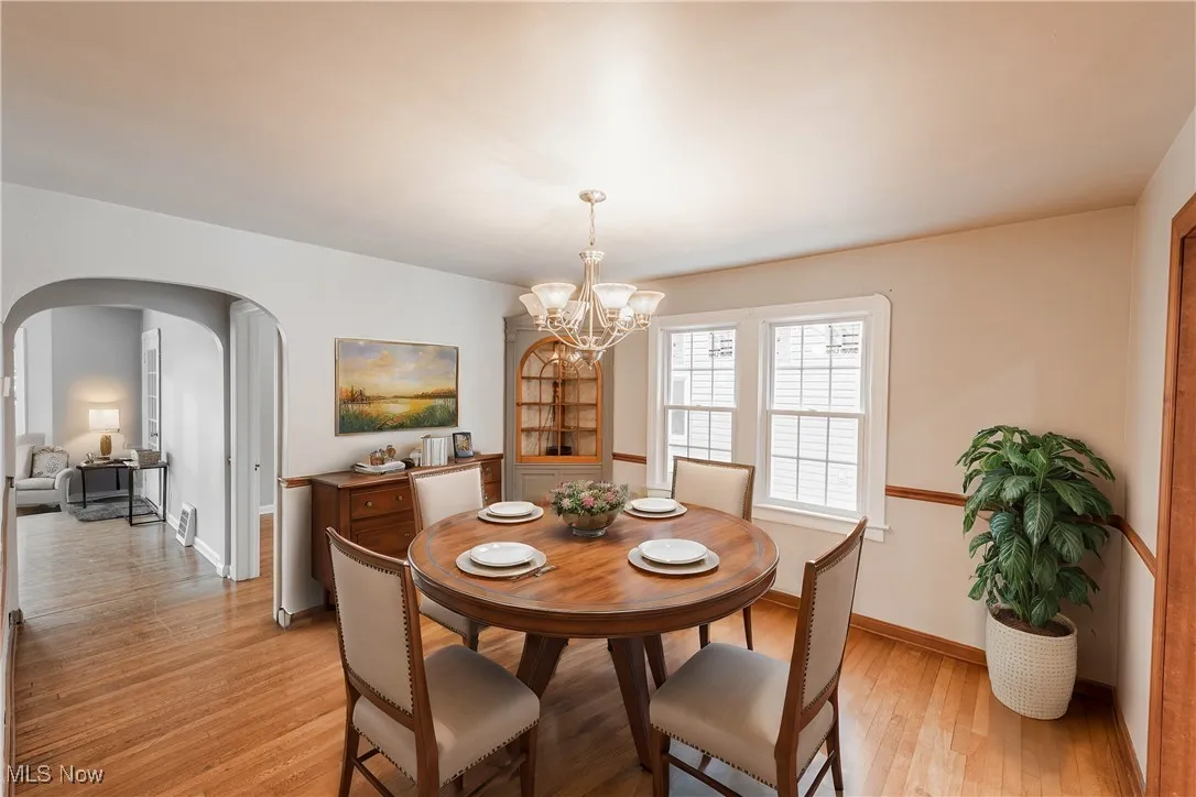 Dining space featuring a notable chandelier and light wood-type flooring (Virturally Staged)