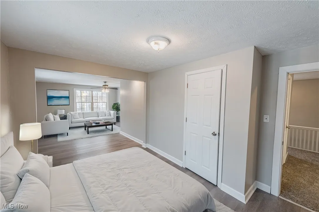 Bedroom featuring wood-type flooring and a textured ceiling (Virturally Staged)