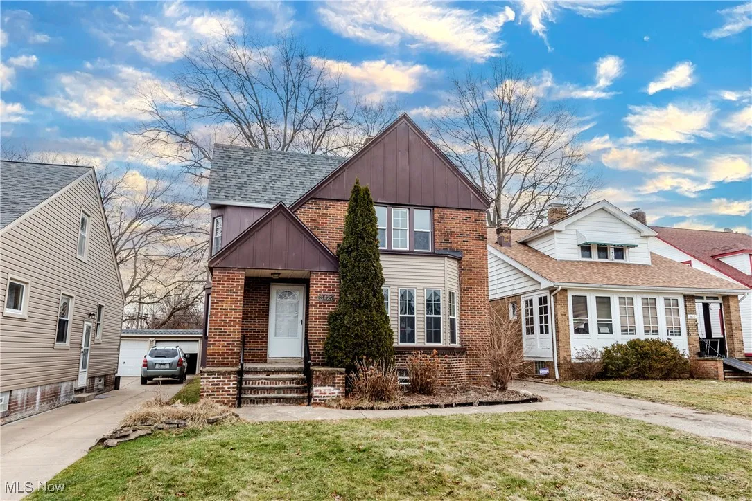 View of front of home featuring a garage and a front lawn