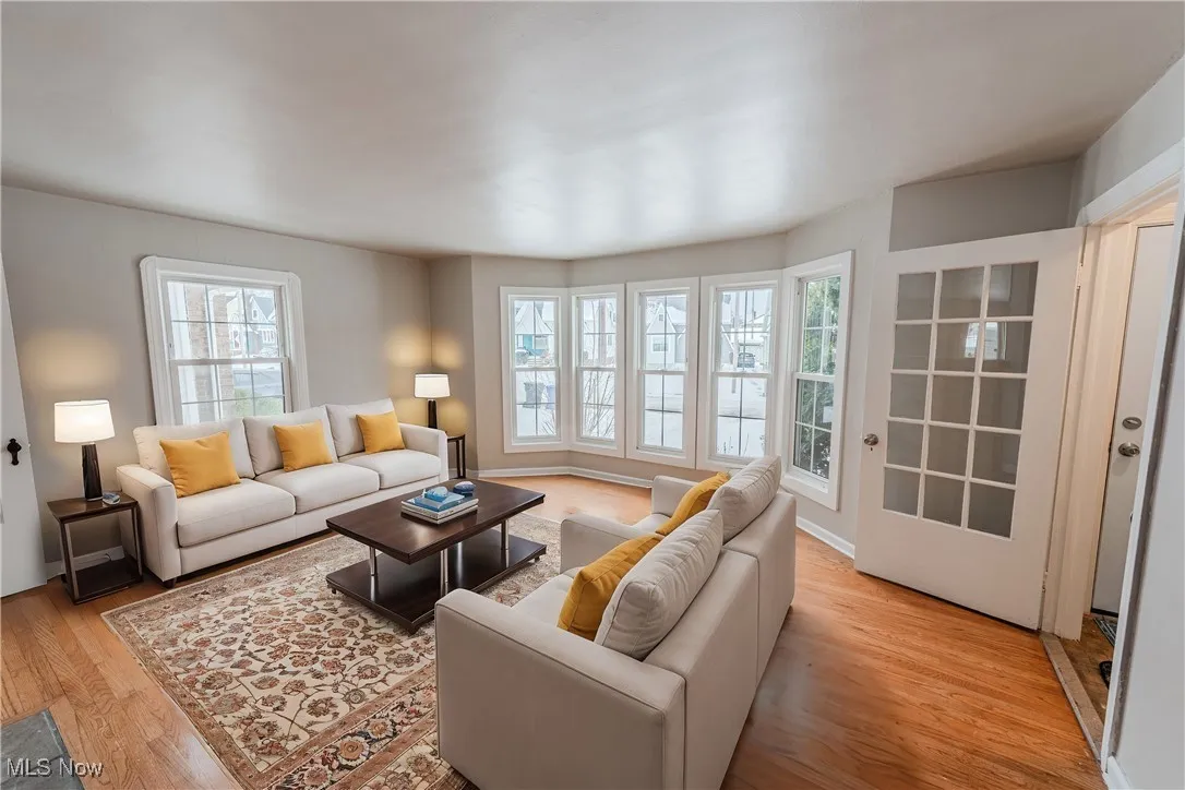 Living room with light hardwood / wood-style flooring (Virturally Staged)