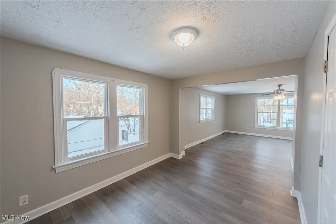 Spare room featuring hardwood / wood-style flooring and a textured ceiling