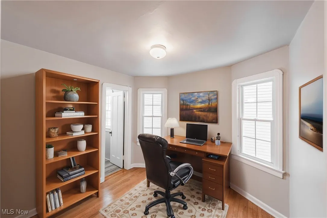 Office space with light wood-type flooring (Virturally Staged)