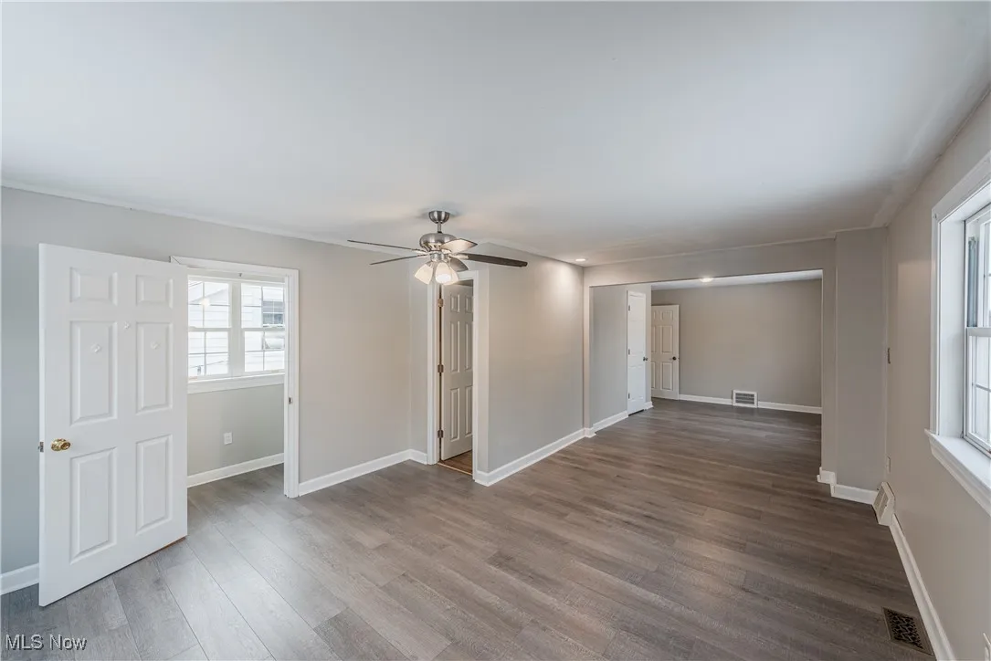 Unfurnished room with ceiling fan and wood-type flooring
