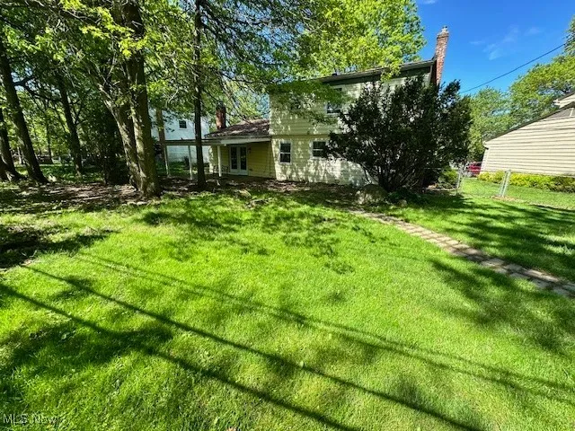 View of grassy yard featuring french doors
