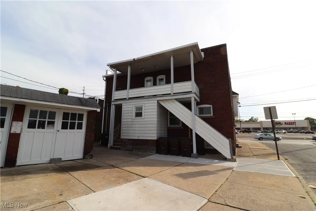 Rear view of property featuring a garage and an outdoor structure