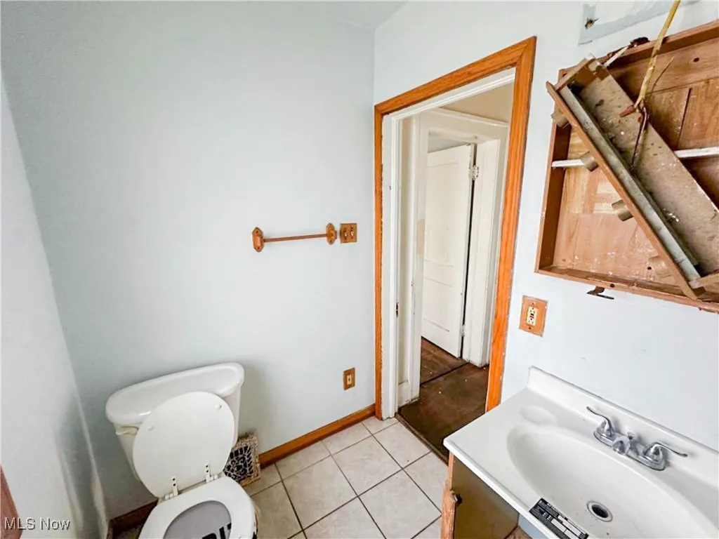 Bathroom with vanity, tile patterned floors, and toilet
