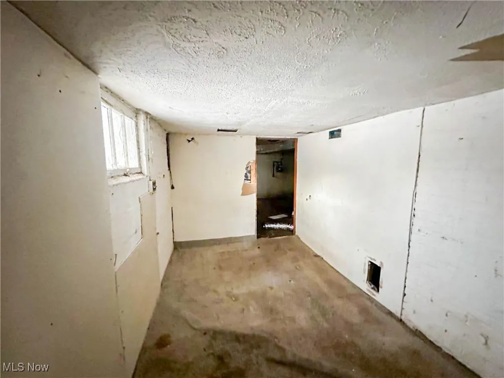 Basement featuring a textured ceiling
