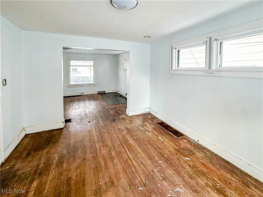 Empty room featuring hardwood / wood-style flooring and a wealth of natural light