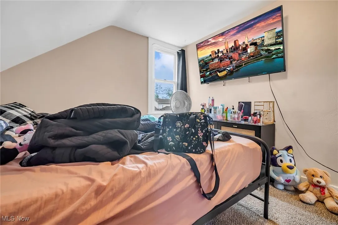 Carpeted bedroom with vaulted ceiling