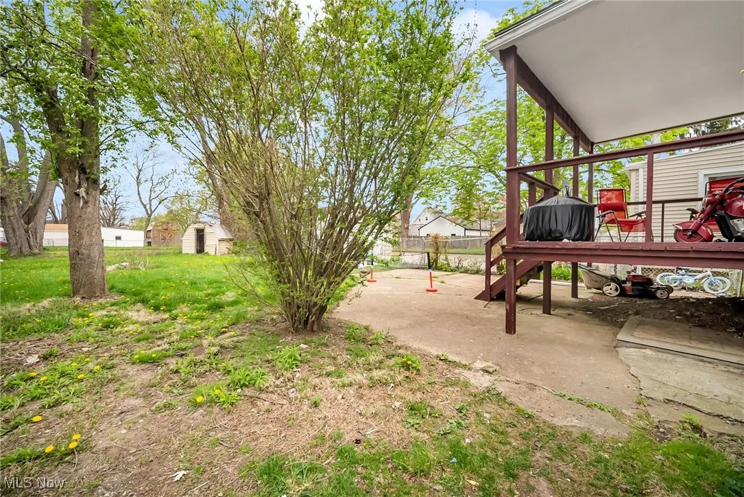 View of yard with fence and a wooden deck