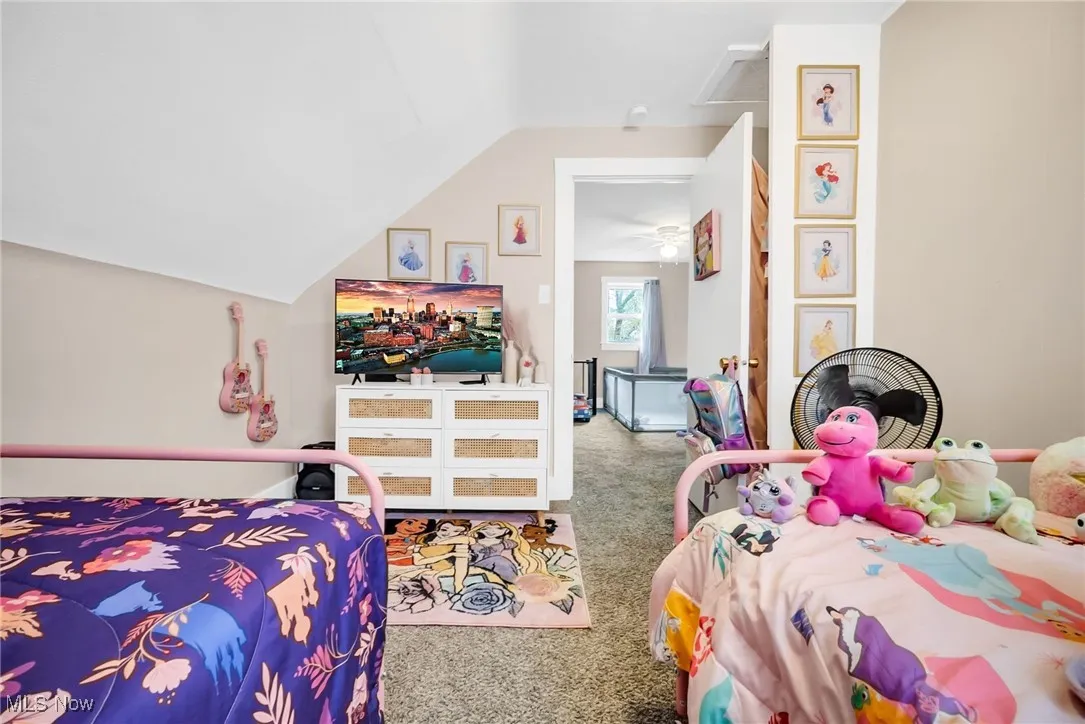 Carpeted bedroom with vaulted ceiling