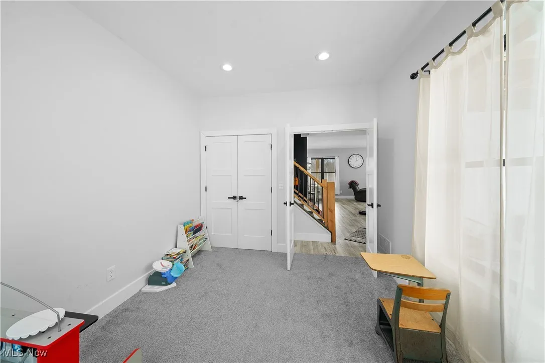 Misc room with light carpet
