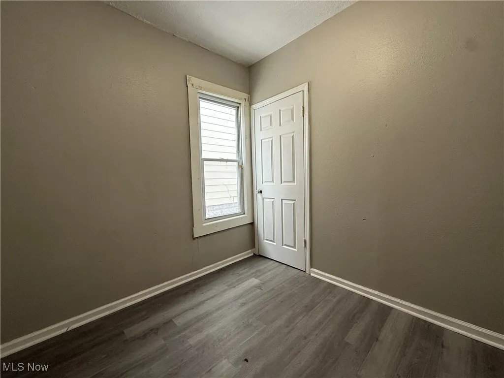Spare room featuring dark hardwood / wood-style floors