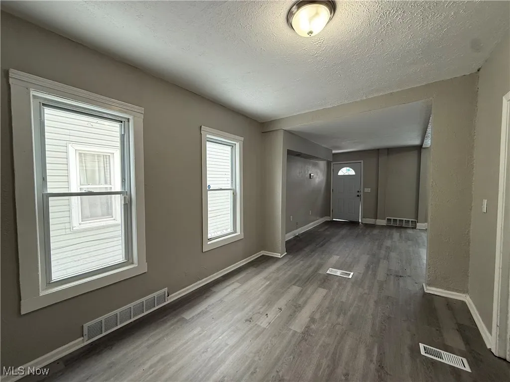 Entrance foyer with hardwood / wood-style floors and a textured ceiling