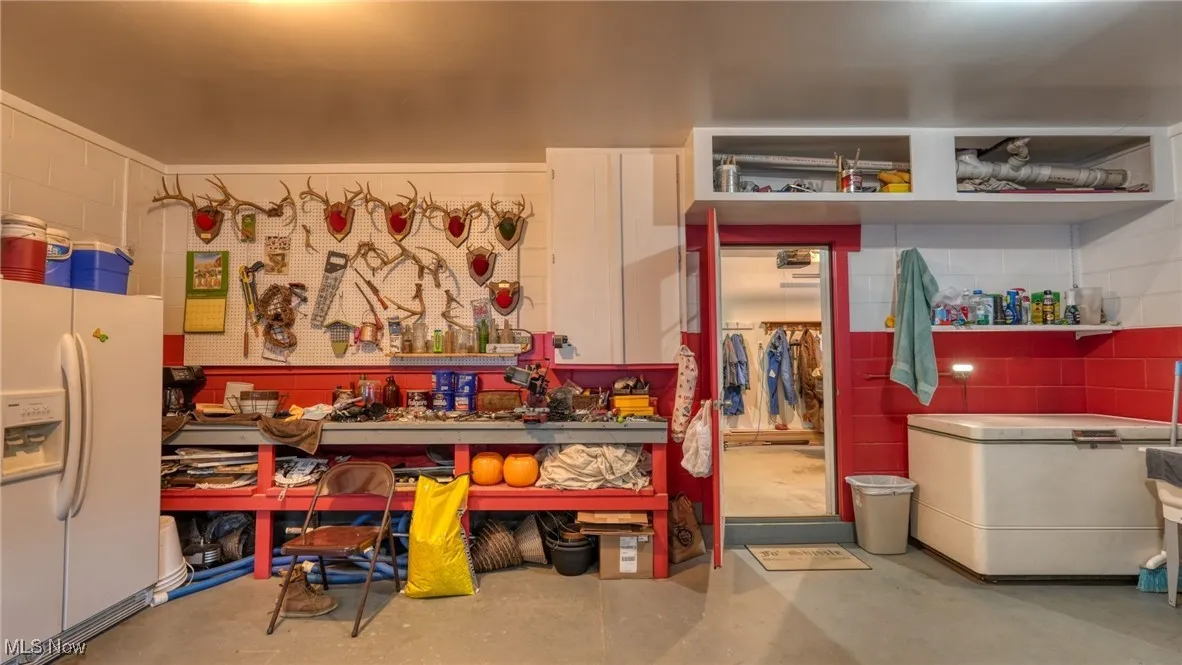Misc room with a workshop area and concrete floors