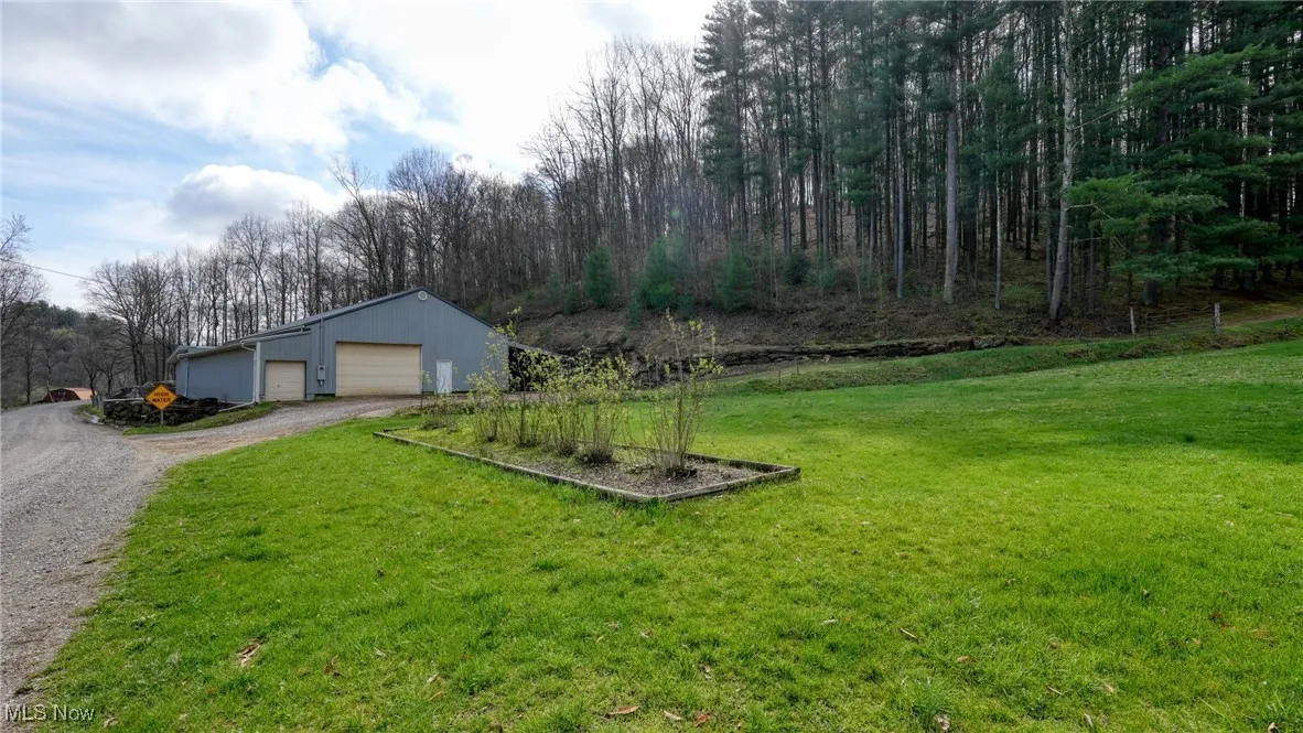 View of yard featuring an outbuilding and a garage