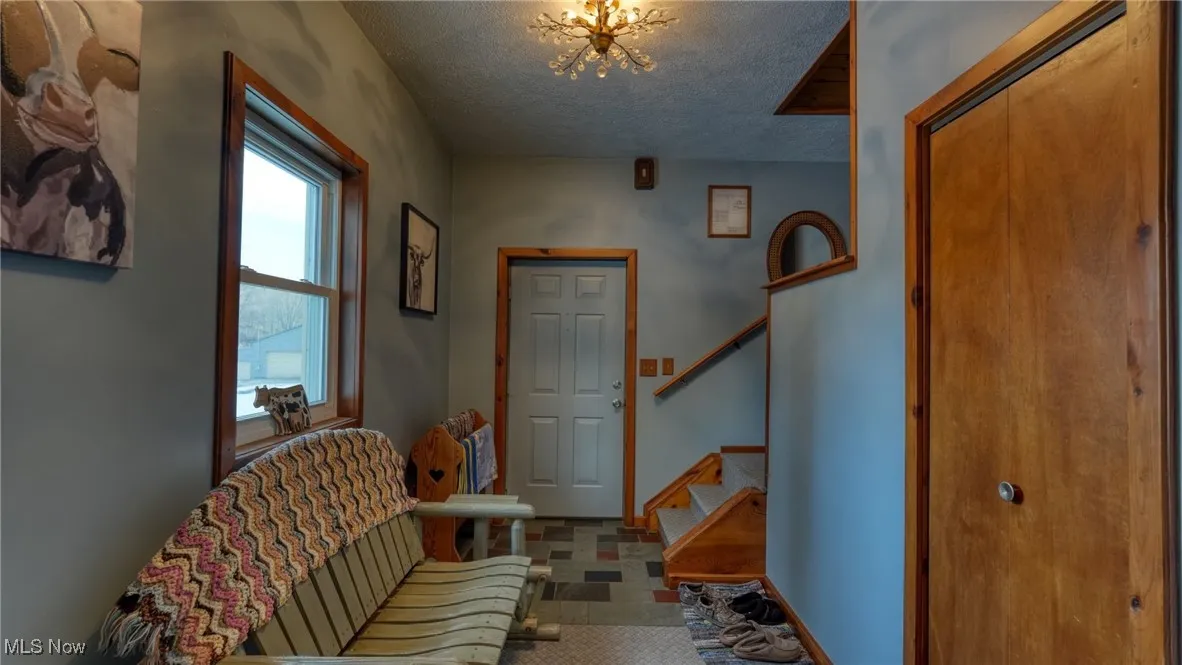 Entrance foyer with a chandelier and a textured ceiling