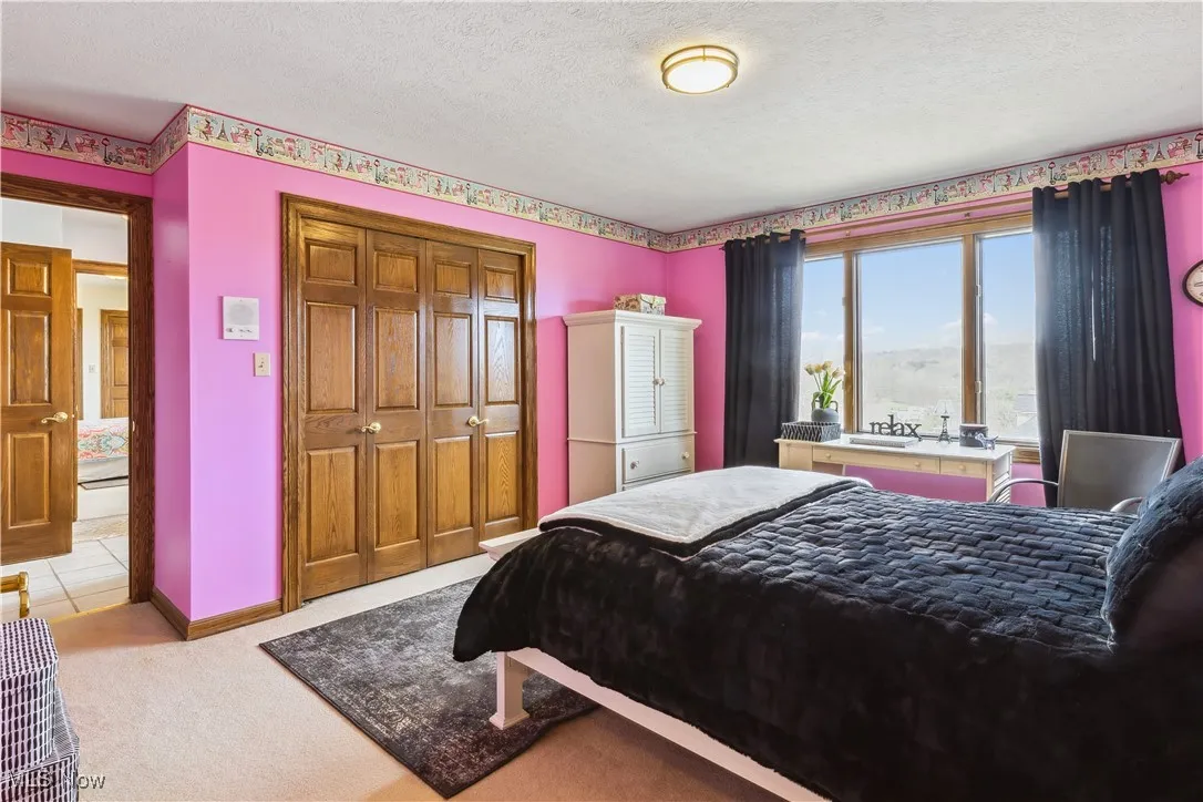 Fourth Bedroom with with huge window that looks out to the neighborhood below