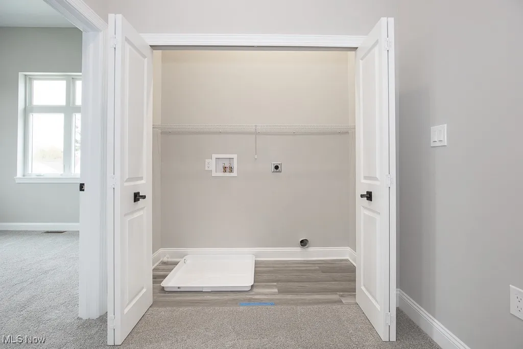 Clothes washing area with hookup for an electric dryer, carpet, and washer hookup