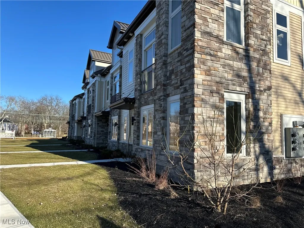 View of side of property with a yard