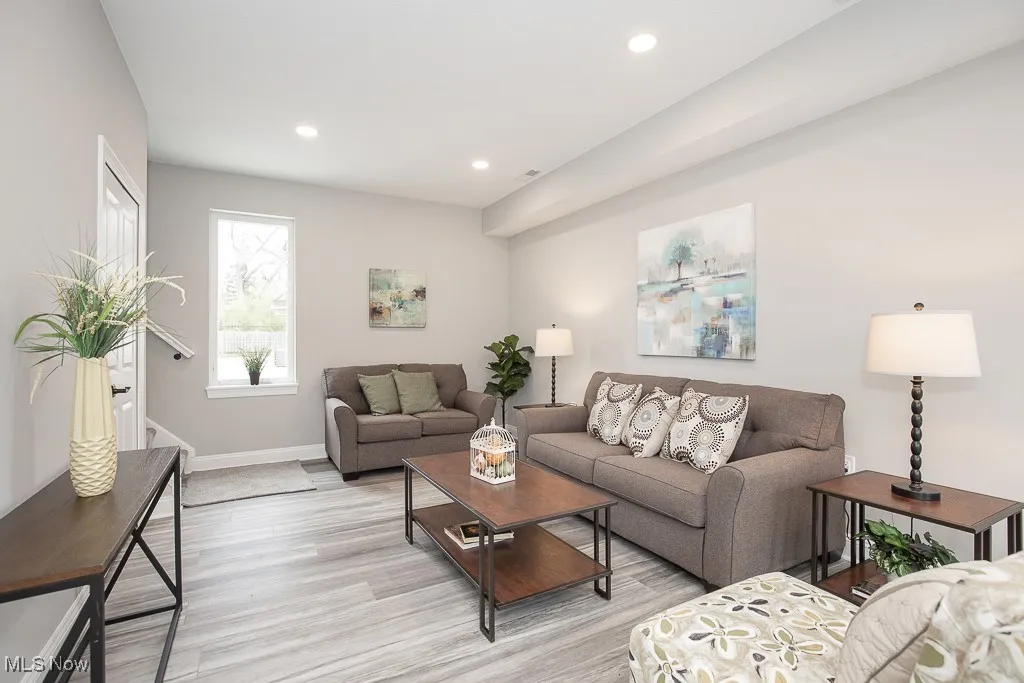 Living room with light hardwood / wood-style flooring