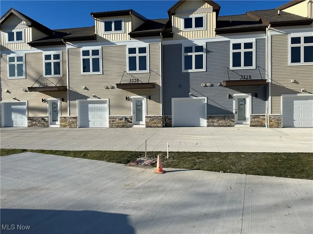 Townhome / multi-family property featuring a garage