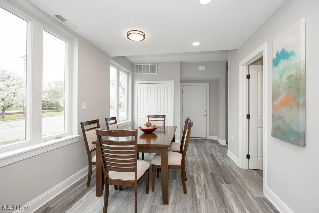 Dining space with a wealth of natural light and light wood-type flooring