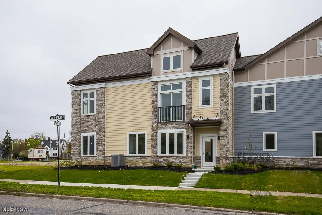 View of front facade with central AC unit and a front yard
