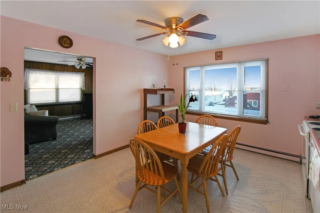 Dining space featuring a baseboard heating unit and ceiling fan