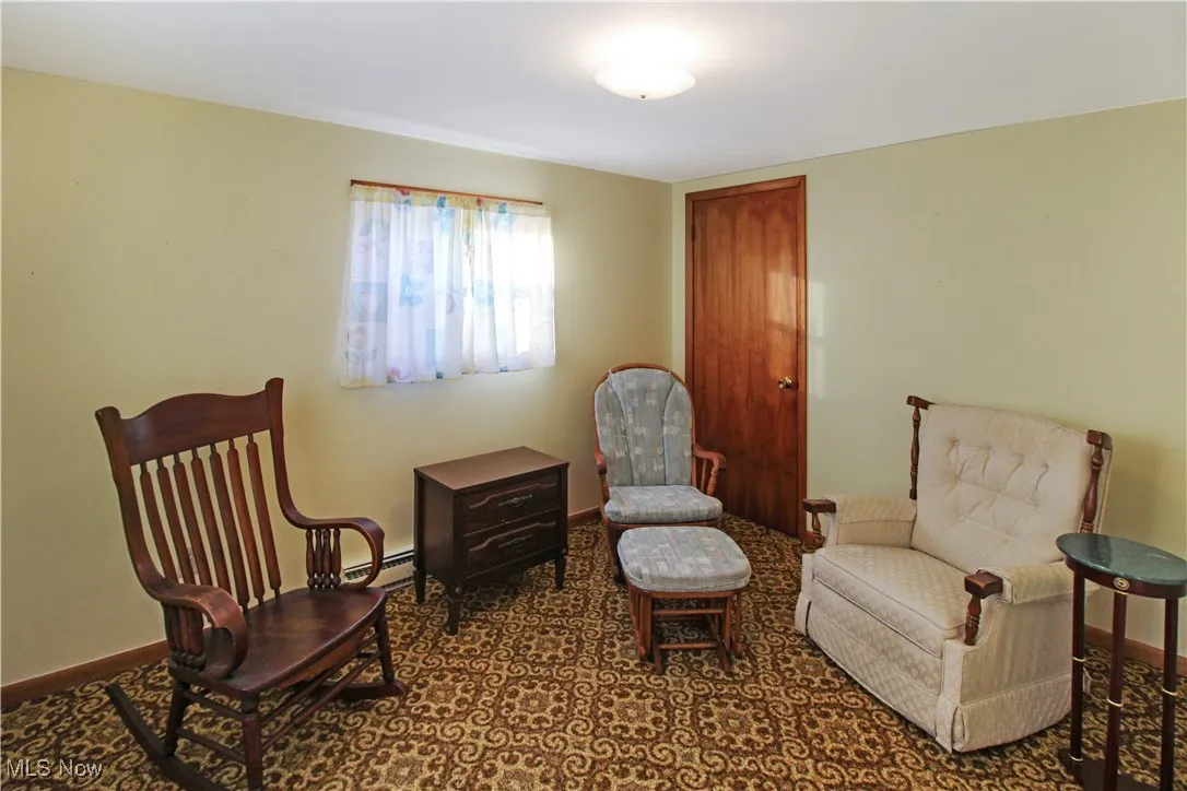 Sitting room featuring a baseboard heating unit