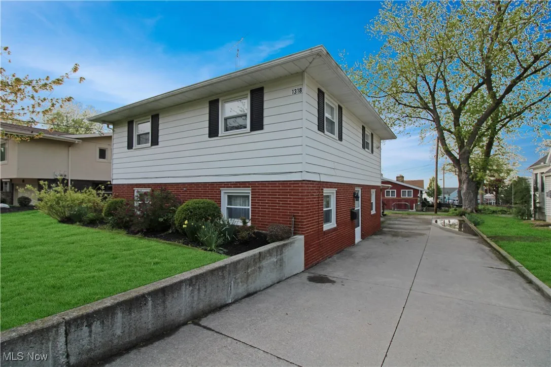 View of side of property featuring a yard